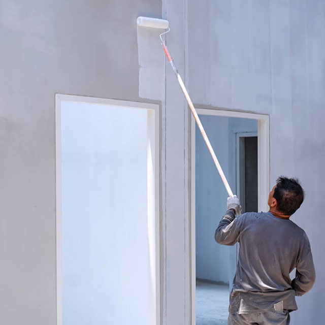 royal-painting-kc-construction-worker-painting-white-primer main painting office building walls white