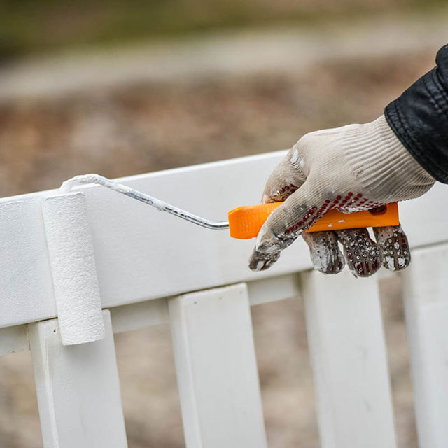 royal-painting-kc-man-paints-garden-furniture-white-with-a-paint-roller-2 professional painted exterior garden furniture with white paint